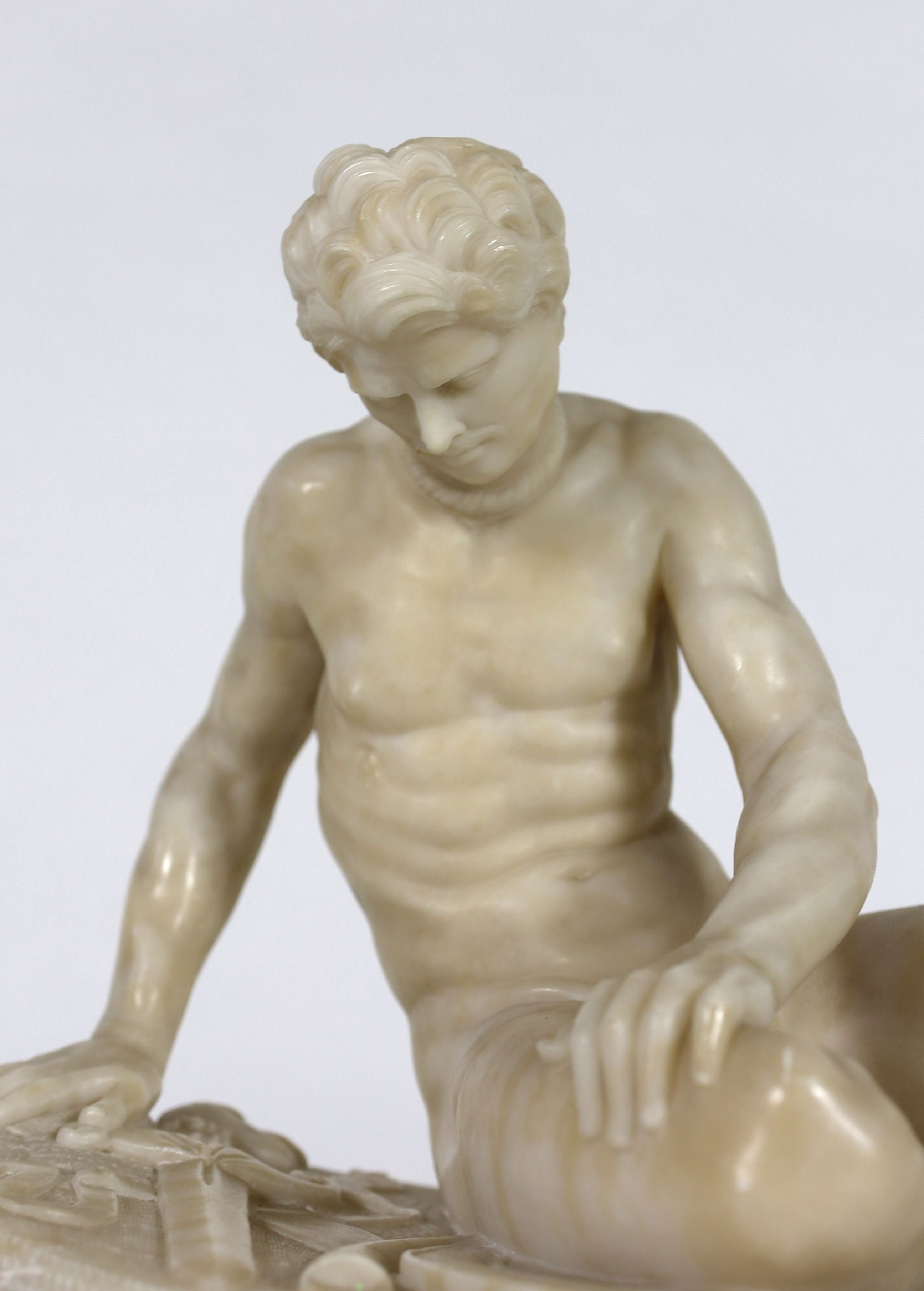 A late 19th century carved alabaster model of The Dying Gaul, width 65cm, height 43cm